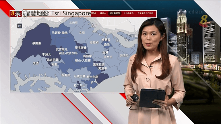 Channel 8 news presenter in front of GIS smart map of Singapore's constituencies