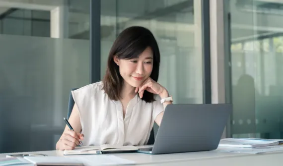 Woman smiling at laptop